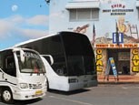 Image of tour buses in front of the Opal Cave